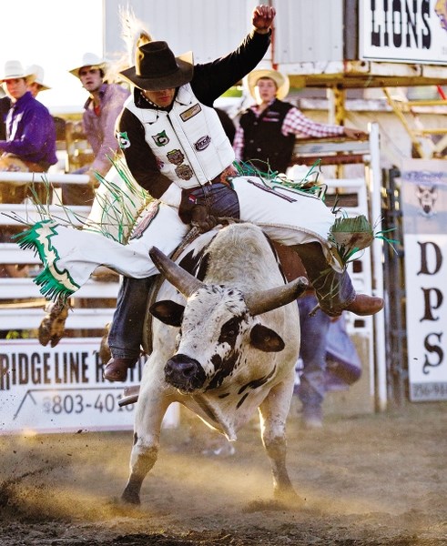 Local cowboy Beau Brooks rides In Color at the annual Cochrane Classic Bull Riding at the Cochrane Lions Rodeo Grounds July 29, 2012.