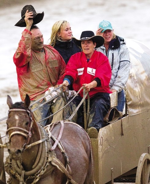 Grant Profit is joined by his family as he salutes the crowd for the final time after his race during the final night of the Rangeland Derby at the Calgary Stampede July 15,