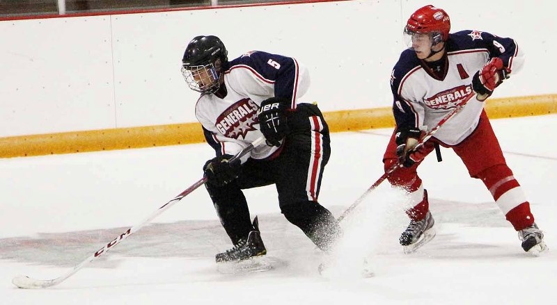 Joel Klassen works to keep the puck away from Dan Bunnah during Cochrane Generals tryouts Sept. 8 at Spray Lake Sawmills Family Sports Centre. The team opened training camp