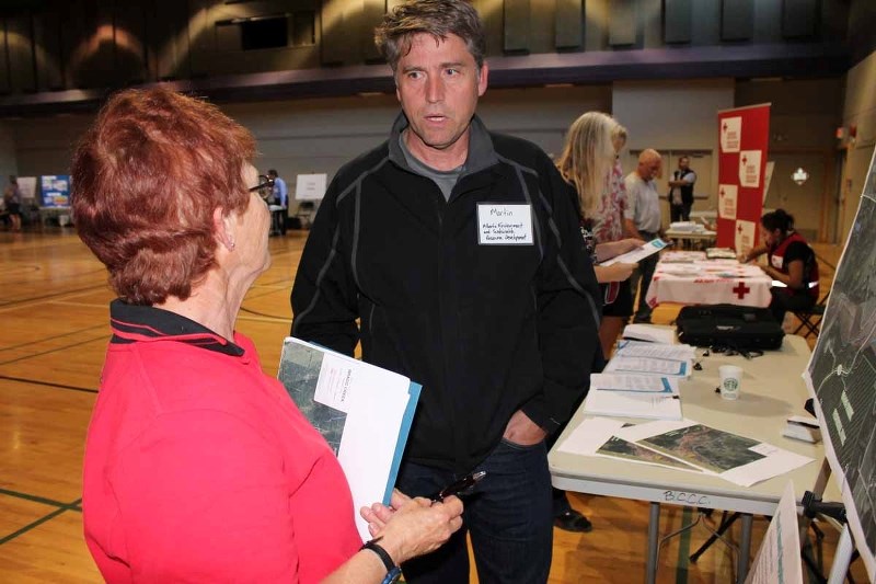 Bragg Creek resident Joan MacKenzie spoke with Martin Foy, an executive director at Environment and Sustainable Resource Development, about flood mapping at a provincial