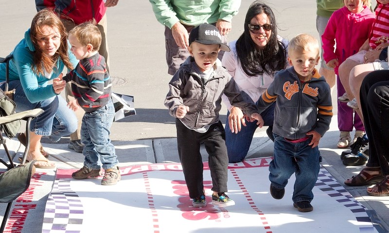 From right: two-year-old Tyler Vidler and Jaxon Cru Edwards-Webb start the first race in the toddler division during the 2012 Four on the Floor Diaper Derby at Grand Avenue