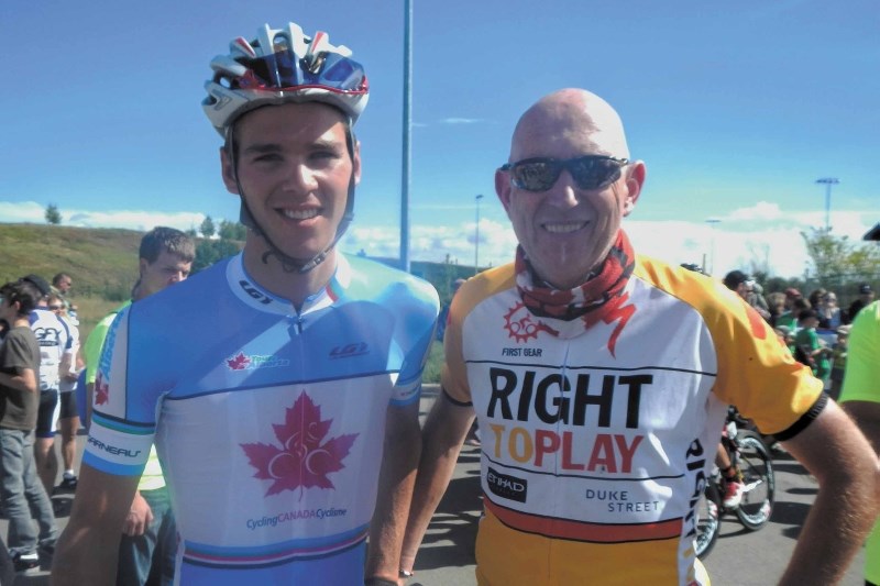 Martin Parnell meets up with Canadian cycling team member Antoine Duchesne in Okotoks during the Tour of Alberta cycling race Sept. 8.