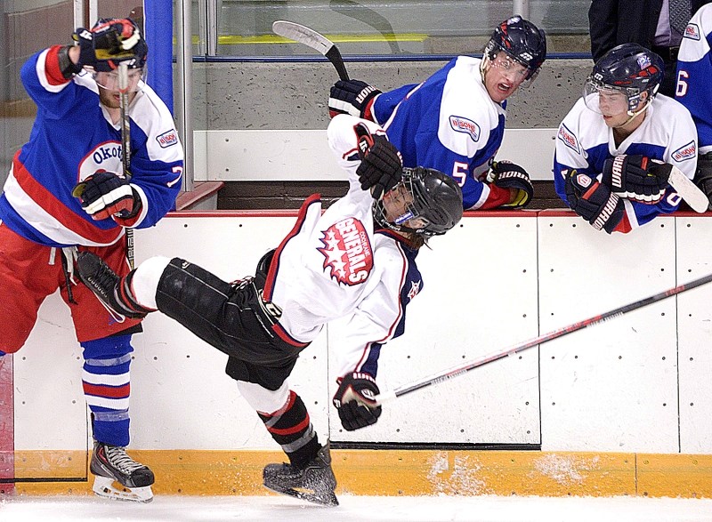 Brett Berndt takes a hit to make a play in the second period as the Cochrane Generals took on the Okotoks Bisons on Sept. 14 in Heritage Junior B League pre-season action at