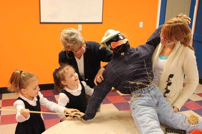 Montessori in the Creek elementary classroom guide Shauna Hay (centre), and classroom assistant Kaitlin Jackson (far right) help their Grade 1 six-year-old twin students make 