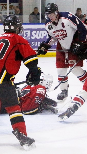 Cochrane Generals forward Andrew Bergmann barges into Airdrie Thunder goalie Kade Taplin&#8217;s crease in Heritage Junior Hockey League season-opening action Sept. 20 in