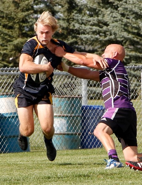 Bow Valley Grizzlies ball-carrier Brandon Harrison avoids a tackle in Calgary Rugby Union Division 3 men&#8217;s semifinal play against Red Deer Titans Sept. 21 at Calgary