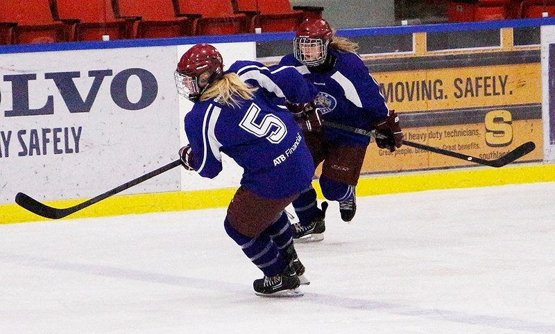 Team Alberta U18 defencemen Daria O&#8217;Neill of Cochrane (left) and Channia Alexander of Bearspaw keep an eye on the action in exhibition hockey play against Rocky