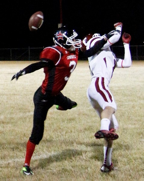 Cochrane High School Cobras defensive back Ethan Forrest tips a ball intended for Chestermere High School Cowboys receiver Maher Hammoud in exhibition football play Oct. 25