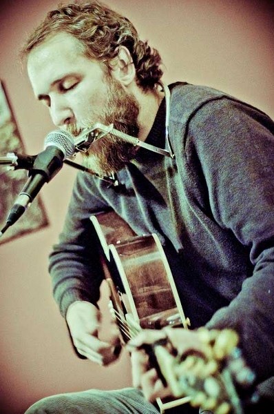 Folk singer Craig Cardiff encourages his fans to write something in his &#8216;Book of Truths,&#8217; which he passes around the audience at his shows.