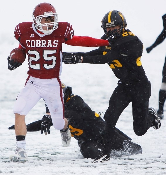 Cochrane High School Cobras tailback Justin Mount barges ahead for yardage in Alberta Schools&#8217; Athletic Association regional playoff football play against the Olds
