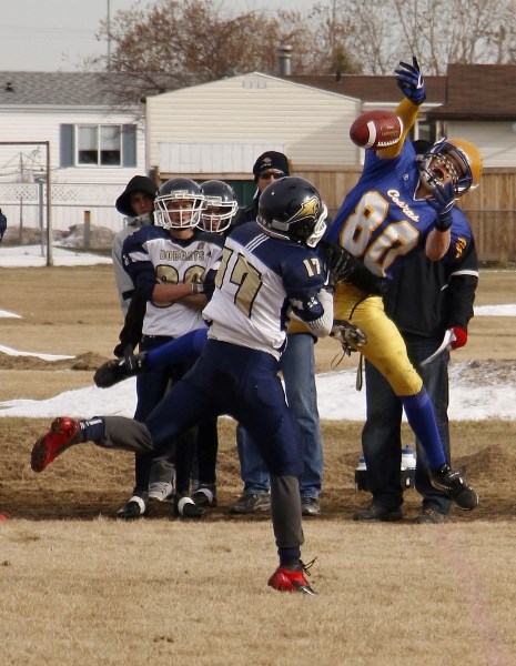 Bow Valley High School Bobcats receiver Grayson Javorsky has a pass knocked away by Willow Creek Composite High School Cobras defender Kody Williamson in provincial high