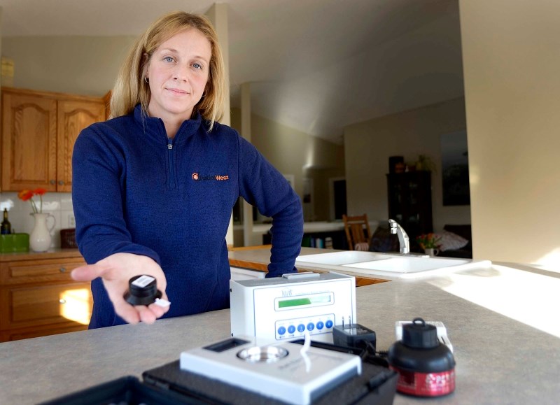 Renata MacQueen of Radon West holds out a radon detector Nov. 27 showing some of the instruments used to detect the known cancer-causing agent that is found in soil