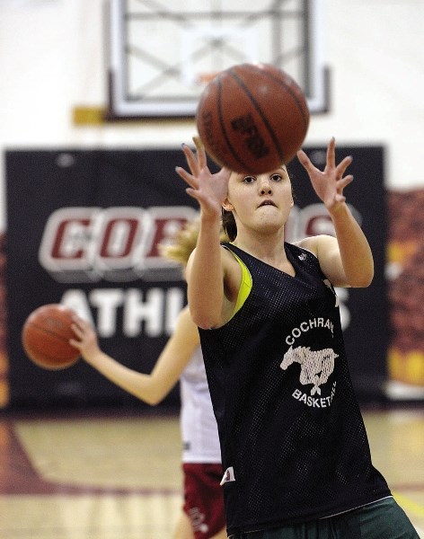 Eliza Donnelly focusses on the ball during Cochrane Cobras senior girls basketball practice Nov. 22.