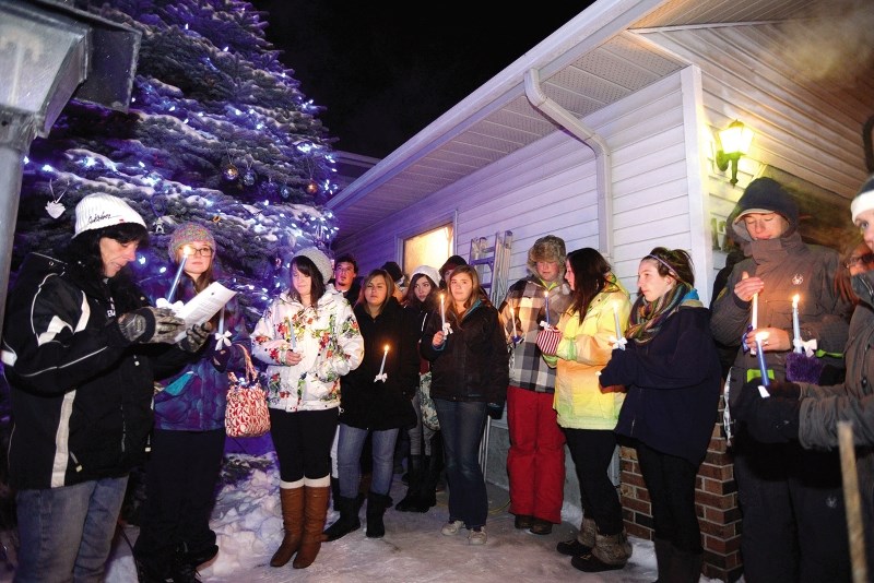 Kim Thomas, far left, mother of Brandon Thomas, the teen who died after a collision with a drunk driver just over a year ago, held a candlelight vigil Dec. 6, 2013 with