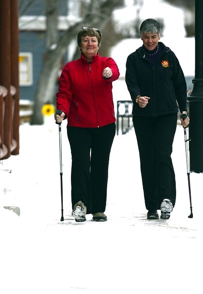 Left, Celia Gjordsund, and Yvette Cleveau participate in “;urban poling”or Nordic walking in Cochrane Jan. 7.