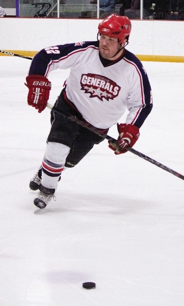Cochrane Generals alum and National Finals Rodeo participant Straws Milan tracks down the puck during the Gens alumni game Jan. 5 at Spray Lake Sawmills Family Sports Centre. 