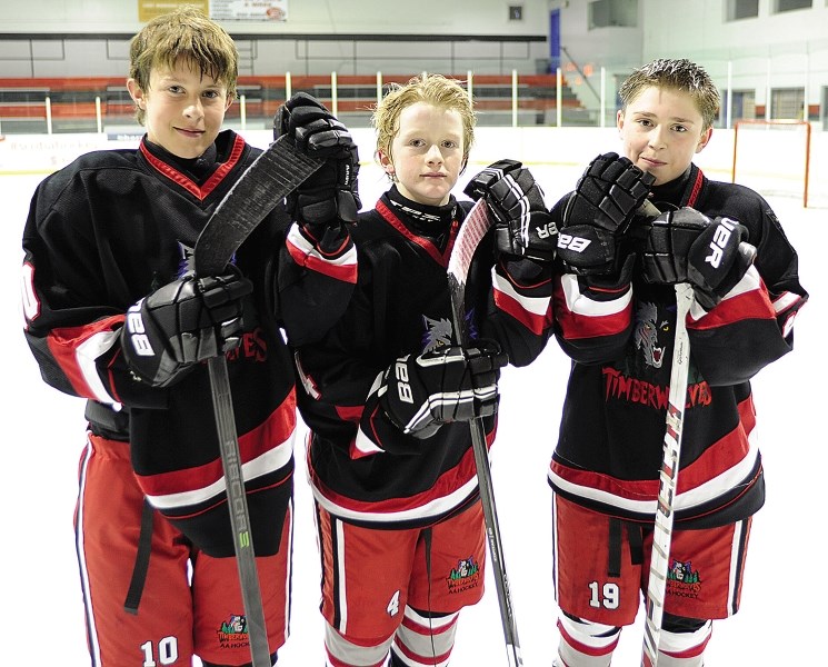 Bow Valley Timberwolves peewee AA players (from left) Kash Rasmussen, Seth Bernard-Docker and Connor Bouchard are three of nine total players from the Timberwolves program to 