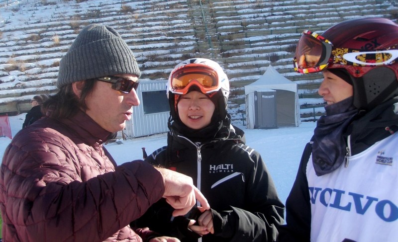 Cochrane&#8217;s Murray Cluff (left) gives pointers to Team China freestyle skiers at a World Cup event earlier this month at Canada Olympic Park. Cluff is off to Sochi for