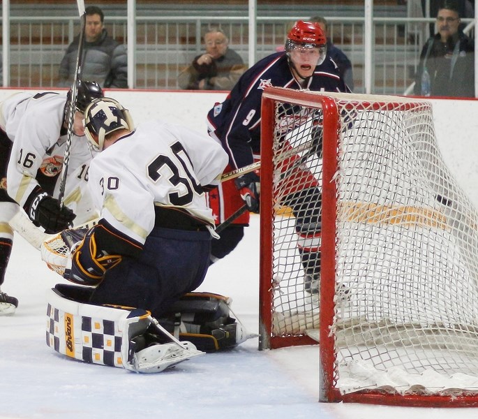 Cochrane Generals forward Andrew Bergmann watches his shot hit the net behind Coaldale goalie Danile Wenham. The visiting Copperheads won the Heritage Junior Hockey League