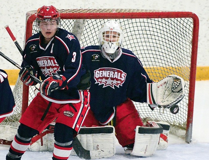 Cochrane Generals defenceman Austin Keller and goalie McKenzie Chalmers stare down the puck in Heritage Junior Hockey League play against the Airdrie Thunder Feb. 1 in