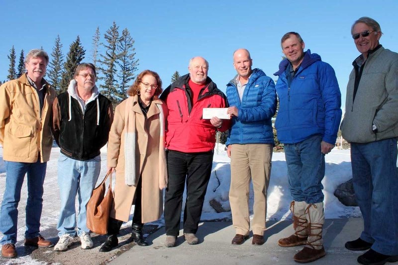 Banff-Cochrane MLA Ron Casey presents a $125,000 cheque from the provincial government to Greater Bragg Creek Trails Association president Robert Sadee in Bragg Creek Jan.