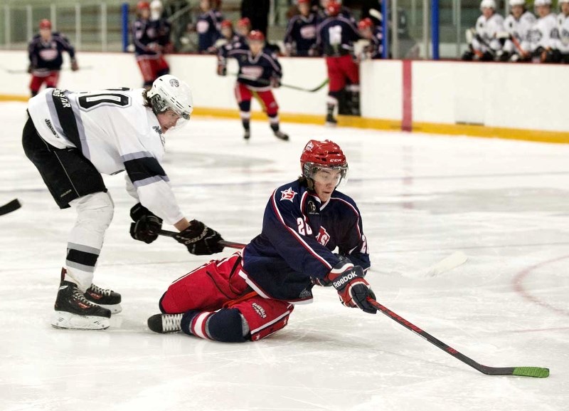 Cochrane Generals forward Brett Berndt handles the puck while sliding on the ice in Heritage League play against Medicine Hat on Feb. 17 at Spray Lake Sawmills Family Sports