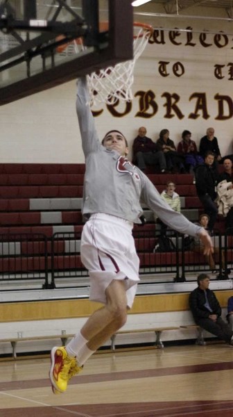 Cochrane High School Cobras&#8217; Kyle Moortgat hauls in a pass (above) during November football playoffs and stuffs a basketball through the hoop during warmups for a Feb.