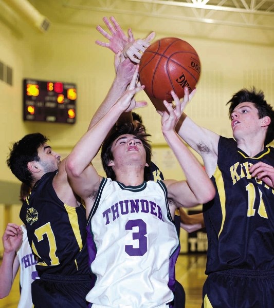 St. Timothy High School Thunder&#8217;s Kade Lappin goes for a rebound in Calgary Senior High School Athletic Association junior-varsity boys basketball play against Queen