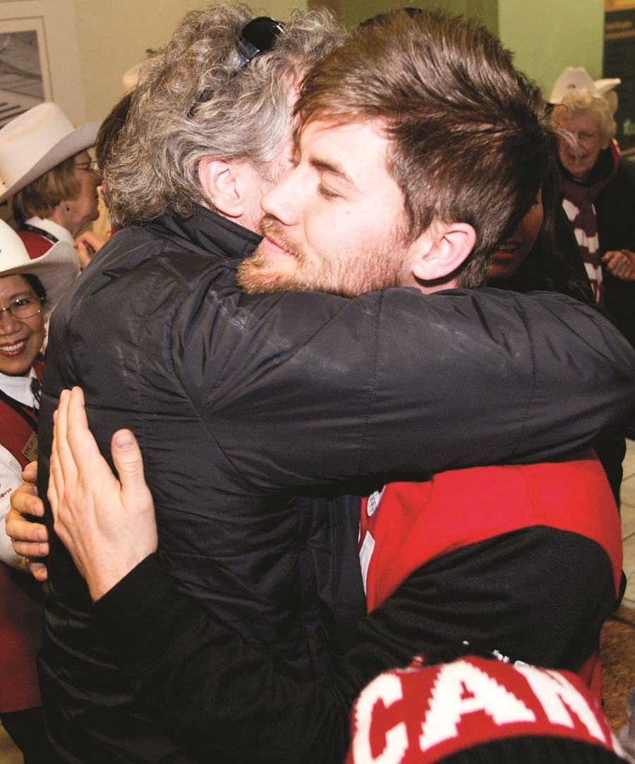 Cochrane luger Tristan Walker gets a big welcome-home hug from dad Bruce at Calgary International Airport on Feb. 24. Walker and the rest of the Canadian Olympic luge team