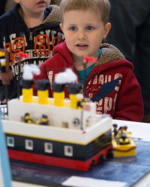 Four-year-old Reid Keyser looks in amazement at the masterful engineering of one of the Lego entries in last year&#8217;s contest.