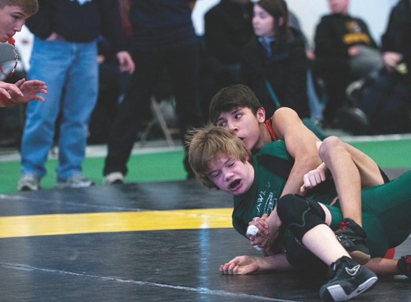 St. Timothy School Thunder and Cochrane Cowboys wrestler Charles Cook (top) wrestles Medicine Hat&#8217;s Alex McNaughton at the Western Canada youth championships March 1 at 