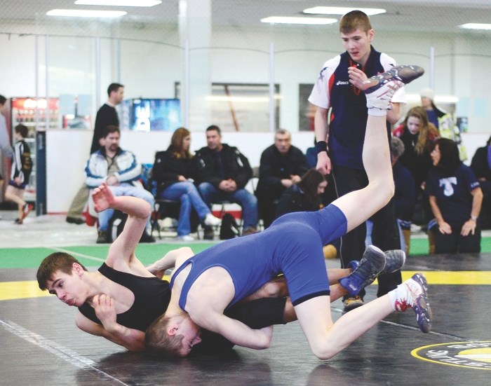 Cochrane Cowboys and St. Timothy Thunder wrestler Rory O&#8217;Donnell (front) wrestles Baynes Coussineau in an exhibition match at the Western Canada youth championships