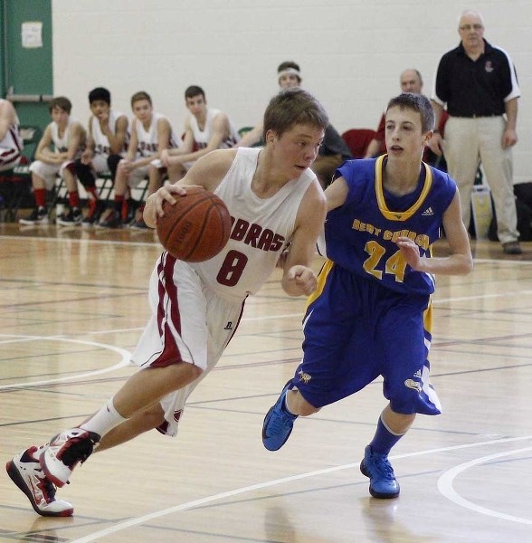 Cochrane Cobras point guard Ethan Forrest takes the play to Bert Church Chargers&#8217; McKay Sera on March 8. Forrest and the Cobras downed the Chargers 67-47 at Springbank