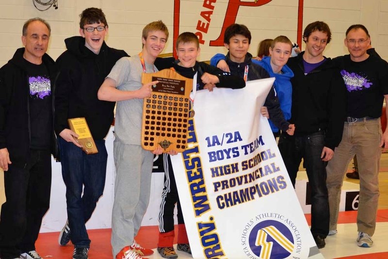 St. Timothy Thunder School wrestlers celebrate their provincial championship March 8 in Calgary. (From left); coach Andy Macri, Luke Clubb, Ryan Loeppky, Callum McNeice,