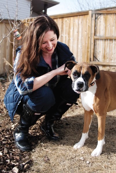 Karla Cox — with her best bud Paxi, a female Boxer — is looking to transform people&#8217;s yards into cost-effective, sustainable sources for food through a process called