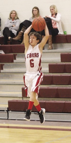Cobras Grade 9 super-sub Sam Bosch goes way up to pull down a high pass in the South Central Zone junior-varsity boys hoops final against Airdrie&#8217;s Bert Church Chargers.