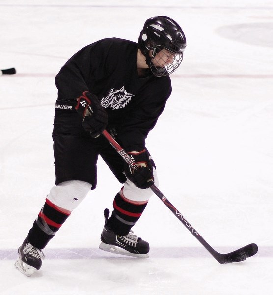 Bow Valley Timberwolves defenceman Noah Bigland handles the puck at the team&#8217;s final practice March 18 ahead of the Hockey Alberta major midget AA provincials starting