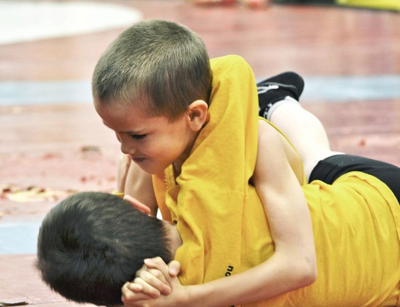 Cochrane Cowboys wrestler Aaron Swedlo grapples in the Elementary division at the Alberta Open wrestling championships March 15 in Calgary. He was one of 15 Cowboys at the