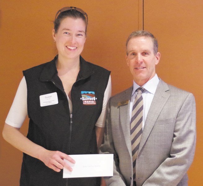 Susan de Caen, left, executive director for the Glenbow Ranch Park Foundation, accepts a $10,000 donation from Tim Harvie, chairman of the Cochrane Foundation.