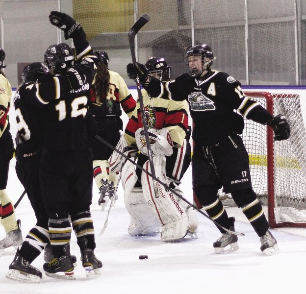 Highwood Raiders forward Gabrielle Seper of Cochrane (right) and her teammates celebrate a goal against the Red Deer Chiefs&#8217; in Alberta Major Midget Female Hockey