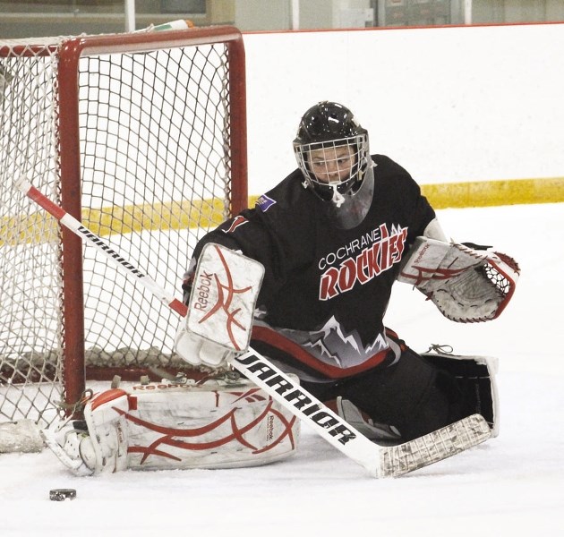 Cochrane Rockies goalie Devin Daviduk kicks the puck out of harm&#8217;s way during Yelnats Cup midget hockey tournament play last year against Ponoka. Twenty-four midget