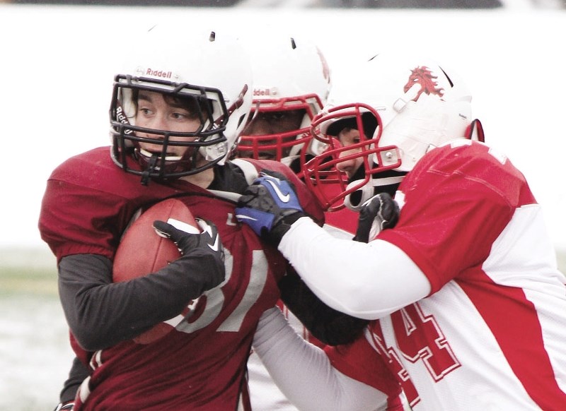 Cochrane Lions receiver Cole Pollard is shoved out of bounds in Calgary Area Midget Football Association pre-season jamboree play against Broncos March 27 at Calgary&#8217;s