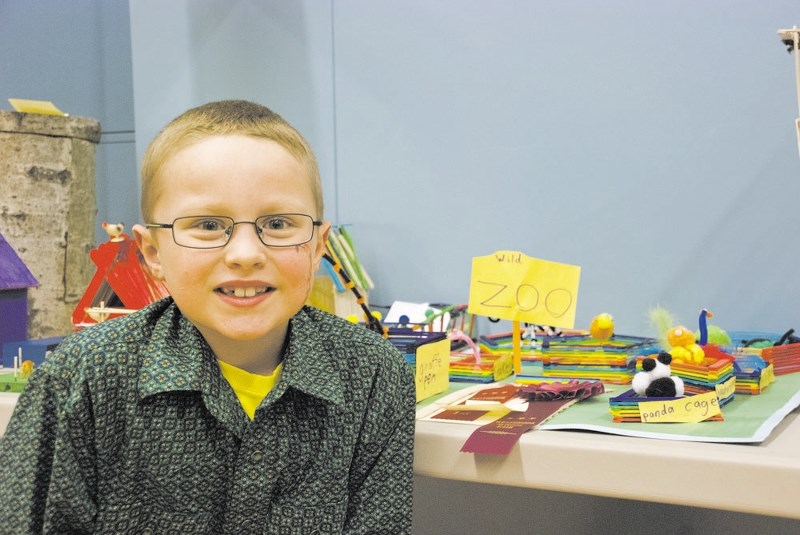 Westbrook School&#8217;s Garrett Ament poses next to his zoo, which he created out of Popsicle sticks and pipe cleaners for the school&#8217;s annual fair last year.