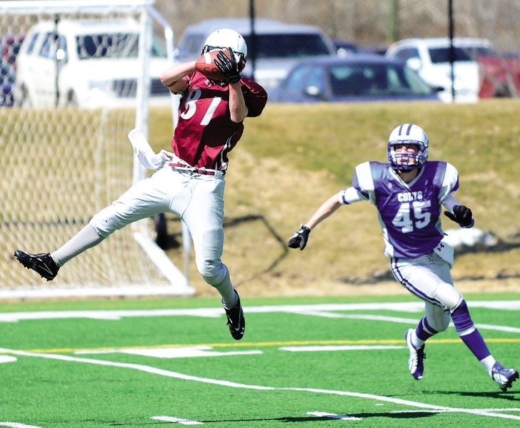 Lions receiver Cole Pollard hauls in a Des Catellier pass in Calgary Area Midget Football Association Week 3 play against Calgary Colts April 19 at Shouldice Park. Lions