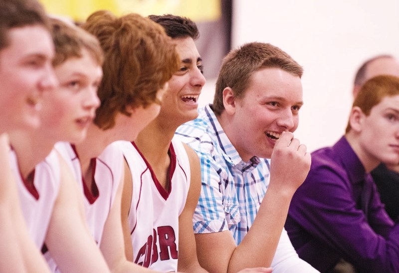 Cochrane High School Cobras multi-sport athlete Brock Wiebe (right) enjoys the antics at a March basketball fundraiser at the school that included members of the Calgary
