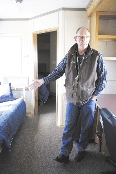 Bill Russell, operations manager for Outland Camps, shows a well-site unit to the Eagle; each interim site has a rec centre with a suggestion box on site.