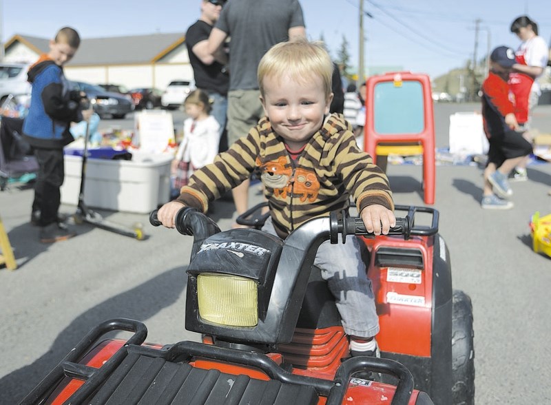 Then one-year-old Easton Hedemann found exactly the toy he wanted, as kids of all ages rummaged through the mass of fun stuff at one of Cochrane&#8217;s larger garage sales