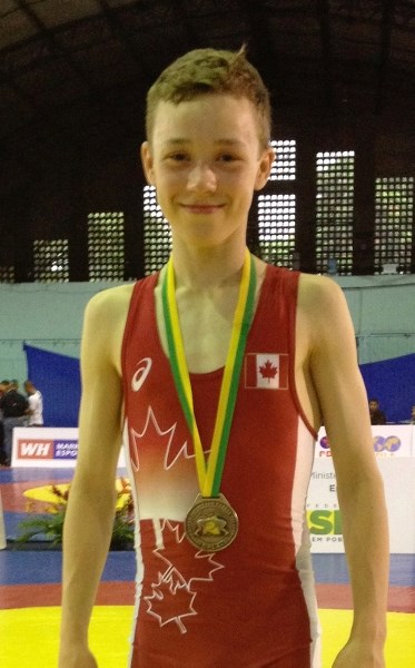 Brendan McKeage displays the FILA Pan-Am cadet wrestling bronze medal he won May 4 in the 42-kilogram division at Recife, Brazil.