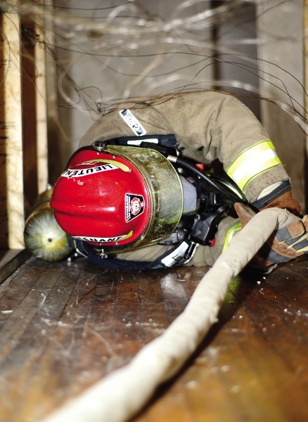 Jeff Avery wriggles his way through a patch of wires, while escaping a home blindfolded.