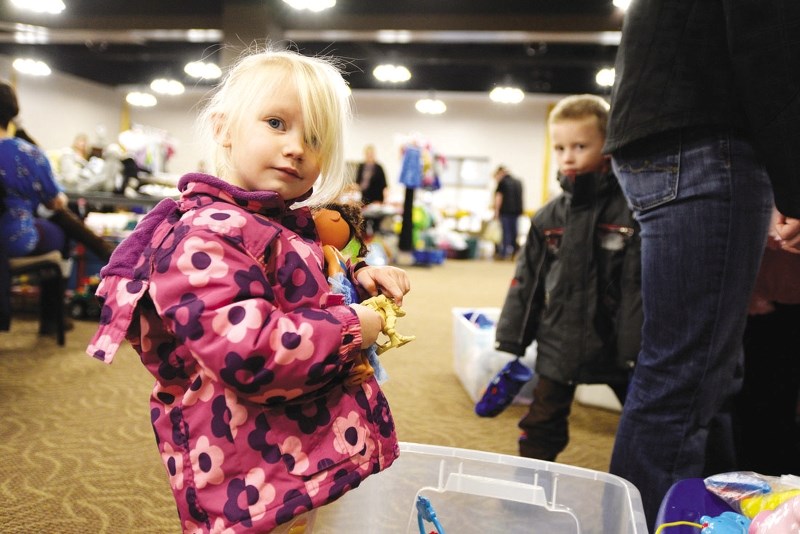 Two-year-old Cadence Searle checks out some of the toys available at the Used Toy and Clothing Sale held at the Cochrane RancheHouse last year.